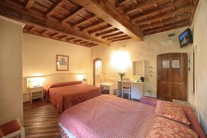 Postel nebo postele na pokoji v ubytování Hotel Villa San Michele