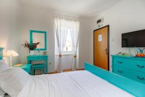 Postel nebo postele na pokoji v ubytování Hotel Sansegus