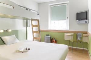 a bedroom with a television and a bed at ibis budget Berlin Alexanderplatz in Berlin