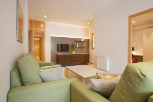 a living room with a couch and a table at Rosselló Apartment in Barcelona