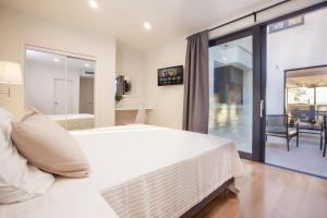 a bedroom with a large white bed and a sliding glass door at Villa Sima in Makarska +27 photos