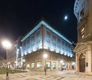 a large building is lit up at night at Capital Hotel Garni in Belgrade