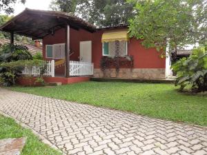 a house with a brick driveway in front of it at Hotel Vivenda Penedo in Penedo