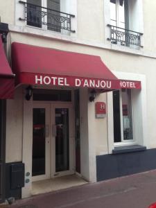 een hotelbord aan de zijkant van een gebouw bij Hôtel D'Anjou in Levallois-Perret