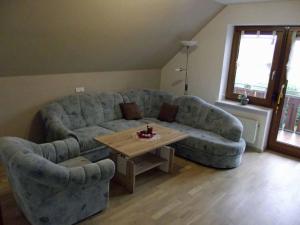 a living room with a couch and a table at Ferienwohnung Reuter Christine in Bad Staffelstein