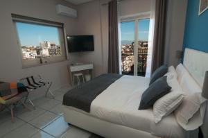 a bedroom with a bed and a view of a city at La Casa di Giorgio Panoramic Rooms in Naples