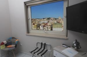 a room with a window with a view of a city at La Casa di Giorgio Panoramic Rooms in Naples