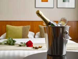 a bottle of champagne in a bucket on a table at K+K Hotel Fenix in Prague