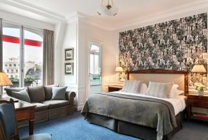 a hotel room with a bed and a couch at Hôtel San Régis in Paris