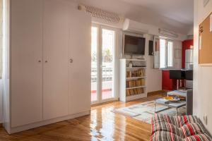 a living room with white cabinets and a tv at Martin&rsquo;s Akropolis loft in Athens