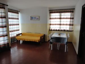 トラダンバーラにあるLamoga Onaのベッド、テーブル、椅子が備わる客室です。