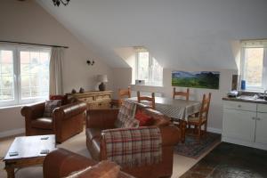 a living room with a couch and chairs and a table at StoneyGill B in Keswick