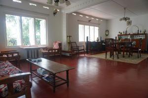a living room with a table and chairs at Sinharaja Tranquil Homestay in Deniyaya