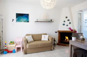 a living room with a couch and a fireplace at case per vacanze torre incina in Polignano a Mare