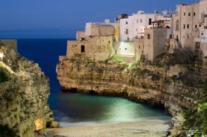 a group of buildings on the side of a cliff at case per vacanze torre incina in Polignano a Mare