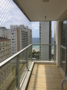 an apartment balcony with a view of a city at Apartamento Guaruja Pitangueiras in Guarujá