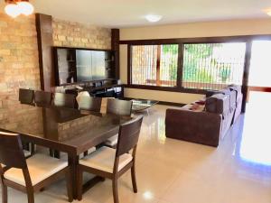 a living room with a table and a couch at Margem da Lagoa Santa in Lagoa Santa