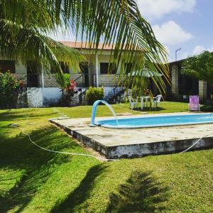 a swimming pool in a yard next to a house at Pousada Cruzeiro dos Anjos in Tabatinga +12 photos