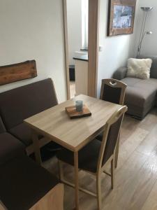 a wooden table and chairs in a living room at Bergsuite NO.27 in Braunlage +6 photos