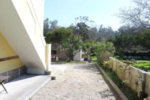 a porch of a house with a table and a fence at Casa de alojamento local (T2) Queluz de Baixo in Oeiras