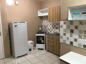 a kitchen with a refrigerator and a stove at Apto próximo ao Shopping Iguatemi e Centro de Eventos in Fortaleza