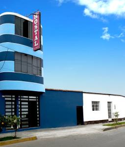 a blue and white building with a sign on it at Hostal Los Angeles in Barranca