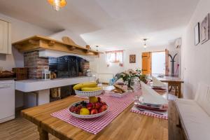 a kitchen with a table with a bowl of fruit on it at Apartments Rensi in Zadar