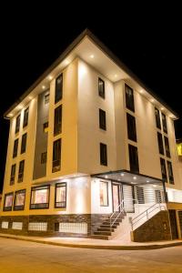 a large building with stairs in front of it at night at Ureta Hotel in Cusco