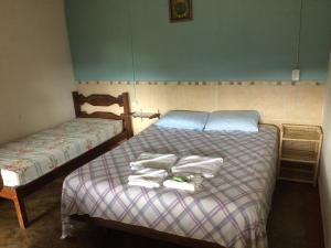A bed or beds in a room at Pousada Estância Macaúbas -