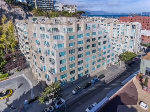 an overhead view of a large white building with cars parked outside at Serene Condo in SF/North Beach/Telegraph Hillside in San Francisco