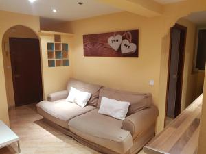 a couch in a living room with hearts on the wall at Pradera de San Isidro in Madrid