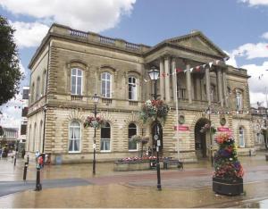 a large building with a christmas tree in front of it at Pilkingtons Guest House Accrington in Accrington