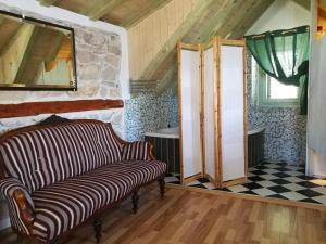 a living room with a couch and a checkered floor at Buena Vis-ta Apartments with the Sea View in Vis
