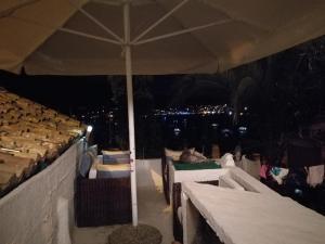 a patio with an umbrella and some tables and chairs at Buena Vis-ta Apartments with the Sea View in Vis