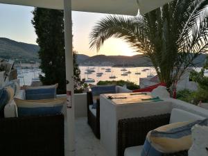 a patio with a table and chairs and a view of a harbor at Buena Vis-ta Apartments with the Sea View in Vis