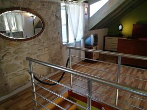 a spiral staircase with a mirror on the wall at Buena Vis-ta Apartments with the Sea View in Vis