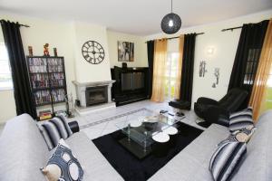 a living room with a couch and a table at Villa do Lago in Silves