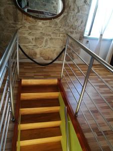 a set of stairs in a room with a stone wall at Buena Vis-ta Apartments with the Sea View in Vis