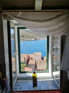 a window in a room with a view of the water at Buena Vis-ta Apartments with the Sea View in Vis