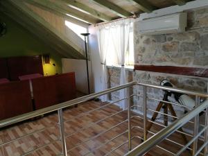 a staircase in a room with a stone wall at Buena Vis-ta Apartments with the Sea View in Vis