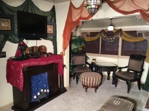 a living room with a fireplace and a tv at 1884 Wildwood Bed and Breakfast Inn in Hot Springs