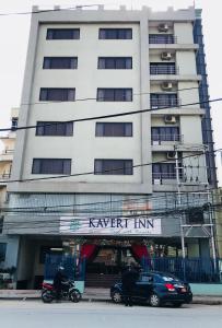 a man on a motorcycle in front of a building at Kaveri Inn in Kathmandu
