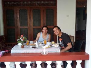 two people sitting at a table with food at Shan Villa in Bentota
