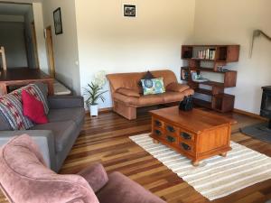 a living room with a couch and a coffee table at Apostle Hideaway - Central Port Campbell in Port Campbell