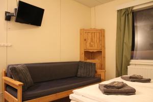 a living room with a couch and a table at B&B RukaTupa in Ruka
