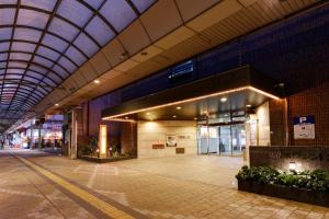 an empty lobby of a building with a ceiling at Kurume Washington Hotel Plaza in Kurume