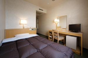 Cama ou camas em um quarto em Kurume Washington Hotel Plaza