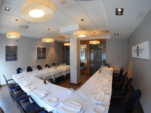 a large conference room with a long table and chairs at Aparthotel Meseguer in Alcañiz