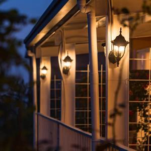 a house with lights on the front porch at Iris Farmhouse in Renai