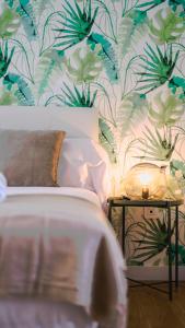 a bedroom with a bed with a plant wallpaper at HQ Rooms Apartments San Vicente in Valencia